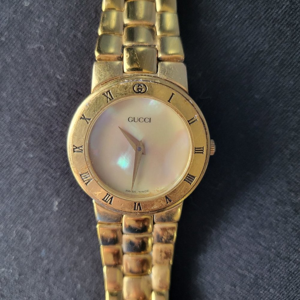 Gucci watch with mother of pearl face